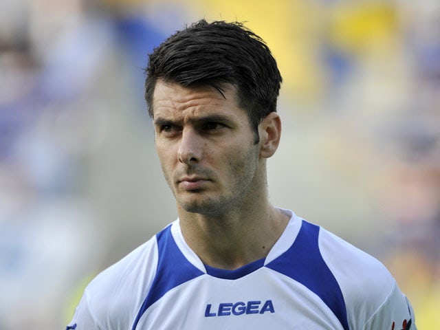 Bosnia's Emir Spahic stands during the playing of the national anthems before the start of World Cup 2014 Group G qualification match between Latvia and Bosnia on June 7, 2013