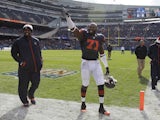 Chicago Bears defensive end Israel Idonije waves into the stands during warmups before the start of an NFL football game on October 28, 2013