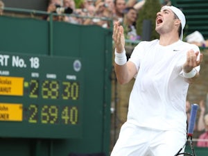 John Isner celebrates beating Nicolas Mahut at Wimbledon.
