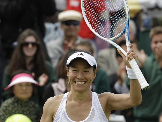 Kimiko Date-Krumm of Japan reacts after defeating Alexandra Cadantu of Romania during their Women's second round singles match on June 27, 2013