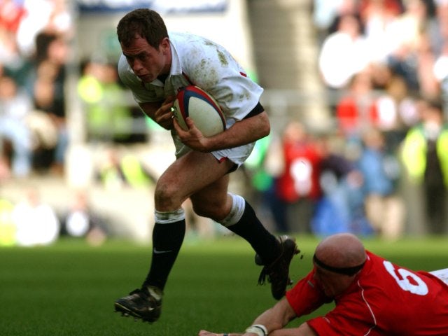 Kyran Bracken skips beyond a tackle while playing for England against Wales.