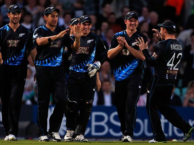 New Zealand players celebrate after taking the wicket of England's Eoin Morgan during their International Twenty20 match on June 25, 2013