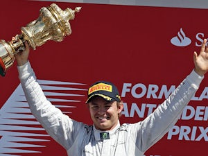 Nico Rosberg celebrates on the podium after winning the British Grand Prix at Silverstone on June 30, 2013