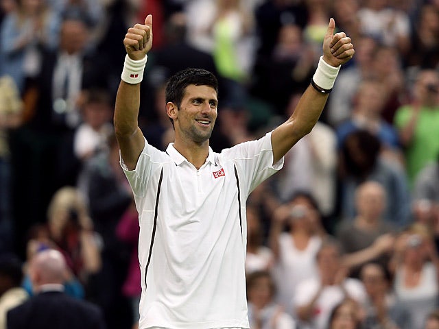 Novak Djokovic celebrates after beating Bobby Reynolds during the second round at Wimbledon on June 27, 2013