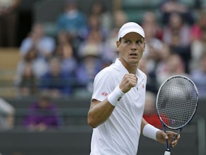 Tomas Berdych of the Czech Republic reacts after winning a point against Martin Klizan of Slovakia during their Men's first round singles match on June 25, 2013