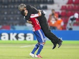 Paraguay's Miller Mareco lifts up Paraguay's head coach Victor Genes after the Under-20 World Cup Group D soccer match between Mexico and Paraguay on June 25, 2013
