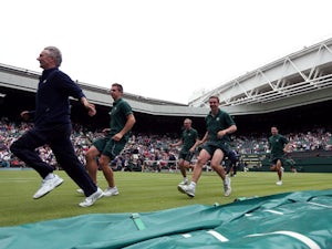 Groundstaff race to put the covers on centre court as rain stops play 
