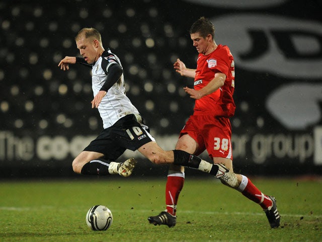 Preston North End's Andrew Procter and Notts County's Neal Bishop battle for the ball on January 24, 2012