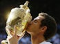 Andy Murray of Britain poses with the Wimbledon trophy after defeating Novak Djokovic of Serbia during the Men's singles final on July 7, 2013