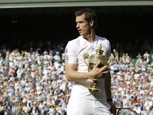 Andy Murray hold the Wimbledon trophy after defeating Novak Djokovic in the final on July 7, 2013