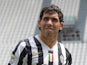 Juventus signing Carlos Tevez wears his new clubs shirt before a press conference on June 26, 2013