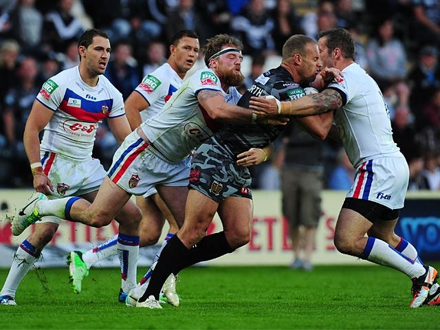 Daniel Holdsworth is tackled by Wakefield Wildcats' Danny Kirmond and Oliver Wilkes during their Super League match on July 1, 2013