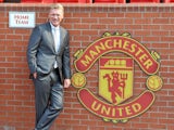 New Manchester United manager David Moyes poses for pictures in the home team dug out on July 5, 2013