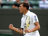 Poland's Jerzy Janowicz celebrates winning the first set against compatriot Lukasz Kubot during their quarter-final match at Wimbledon on July 3, 2013