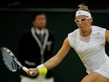 Kirsten Flipkens returns the ball to opponent Petra Kvitova during their Wimbledon quarter final match on July 2, 2013