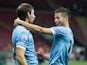 Uruguay's Nicolas Lopez is congratulated by team mate Gaston Silva after scoring the opening goal against Nigeria during the U20 World Cup on July 2, 2013