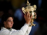 Rafael Nadal celebrates with the Wimbledon trophy.