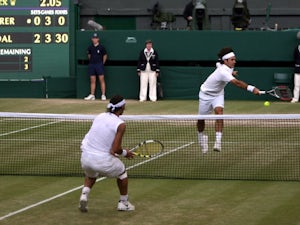 Roger Federer and Rafael Nadal exchange shots at the net during the 2008 Wimbledon final.
