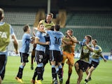 Uruguay players celebrate after scoring the opening goal during extra time of a Under-20 World Cup quarter final soccer match between Uruguay and Spain on July 6, 2013