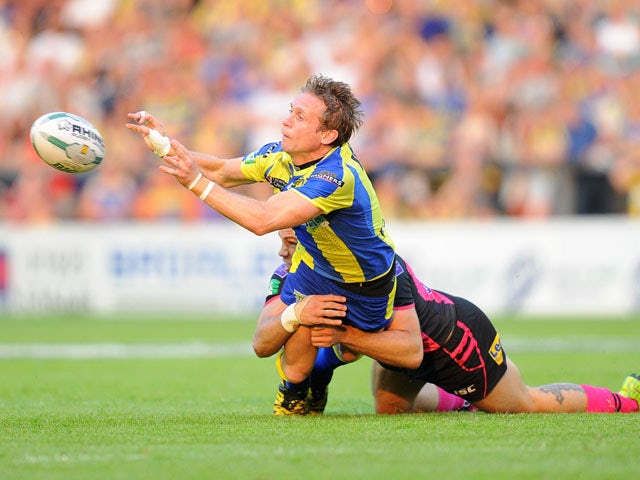 Warrington Wolves' Brett Hodgson is tackled by Leeds Rhinos Joel Moon during the Super League on July 5, 2013