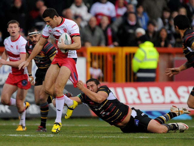 Catalan Dragons' Julian Bousquet tackles Hull KR's Craig Hall during a Super League match on February 3, 2013