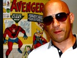 Vin Diesel standing in front of a Marvel poster (640x480)
