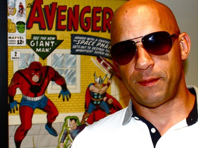Vin Diesel standing in front of a Marvel poster (640x480)
