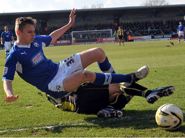 Burton's Anthony O'Connor tackles Chesterfield's Conor Townsend during the npower League Two match on March 30, 2013