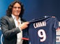 New Paris Saint Germain signing Edinson Cavani poses with his new team's shirt during a press conference on July 16, 2013