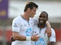 Tottenham's Gareth Bale celebrates with team mate Jermaine Defoe after scoring the opening goal against Swindon in a pre-season friendly on July 16, 2013