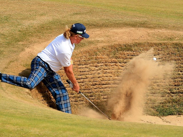 Spain's Miguel Angel Jimenez chips out of the bunker on the fourth hole during day three of the 2013 Open Championship on July 20, 2013