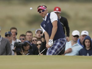 Ian Poulter of England chips onto the 16th green during the final round of the British Open Golf Championship on July 21, 2013