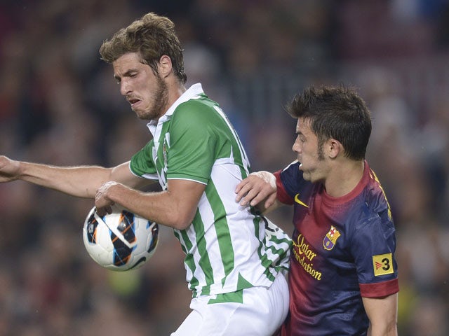 Betis's Ruben Perez duels for the ball with Barcelona's David Villa during the La Liga match on May 5, 2013