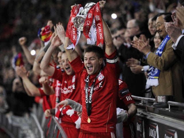 Gerrard lifts the League Cup aloft following Liverpool's win on penalties over Cardiff City in February 2012.