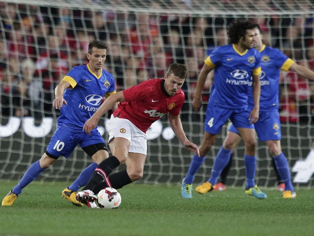 Manchester United Michael Carrick steals the ball off Sydney Allstars' Liam Miller during the exhibition match on July 20, 2013