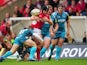 London Welsh's Tom Bristow fumbles the ball before being tackled by Gloucester's Dave Lewis on September 30, 2012