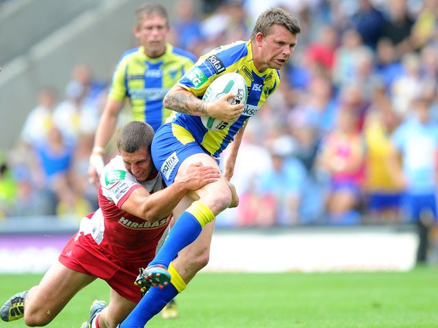 Warrington Wolves' Lee Briers is tackled by Hull Kingston Rovers' Richard Beaumont during the Super League match on July 21, 2013