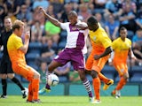 Aston Villa's Leandro Bacuna battles for possession of the ball with Wycombe Wanderers' Anthony Stewart and Stuart Lewis during the friendly match on July 20, 2013