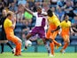 Aston Villa's Leandro Bacuna battles for possession of the ball with Wycombe Wanderers' Anthony Stewart and Stuart Lewis during the friendly match on July 20, 2013