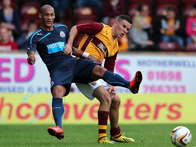 Newcastle United's Yoan Gouffran and Motherwell's Simon Ramsden battle for the ball during a pre-season friendly on July 16, 2013