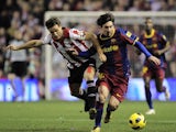 Athletic Bilbao's Carlos Gurpegui duels for the ball with Barcelona's Lionel Messi on January 5, 2011