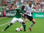 Werder Bremen's Cedrick Makiadi and Fulham's Dimitar Berbatov battle for the ball during a friendly match on July 28, 2013