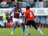 Aston Villa's Christian Benteke and Luton Town's Solomon Taiwo battle for the ball during a friendly match on July 23, 2013