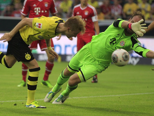 Dortmund's Marco Reus heads the ball to score against Bayern goalkeeper Tom Starke during the Super cup match on July 27, 2013