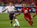 Liverpool's Iago Aspas and Thailand's Pokklao Anun battle for the ball during a friendly match on July 28, 2013