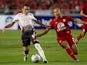 Liverpool's Iago Aspas and Thailand's Pokklao Anun battle for the ball during a friendly match on July 28, 2013