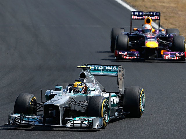 Lewis Hamilton steers his car ahead of Sebastian Vettel during the Hungarian Grand Prix on July 28, 2013