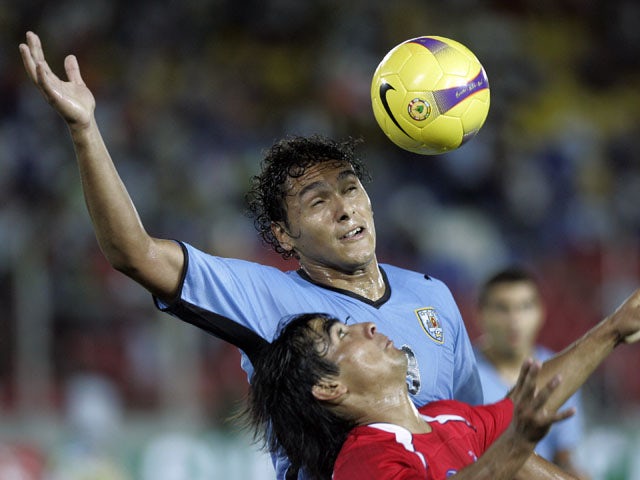 Uruguay's Marcelo Silva fights for the ball with Chile's David Llanos during an under-20 South American soccer game on January 22, 2009