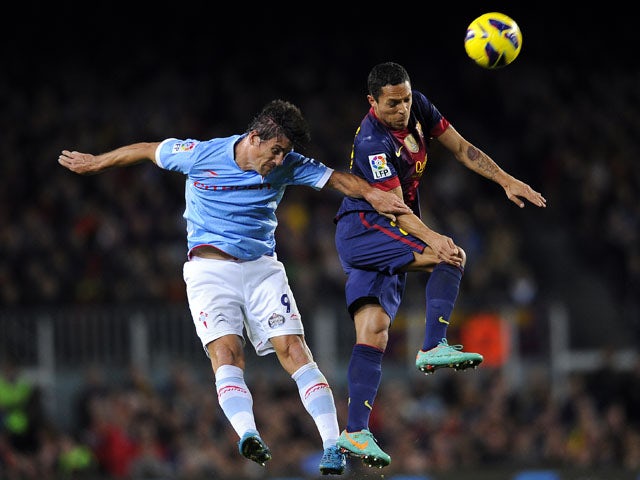 Celta Vigo's Mario Bermejo duels for the ball with FC Barcelona's Adriano on November 3, 2012