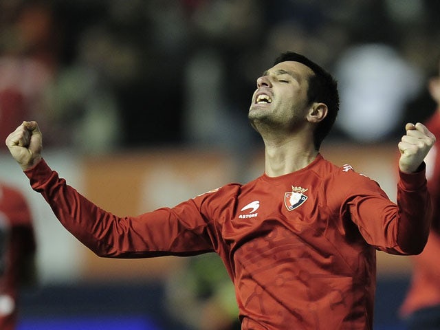 Osasuna's Miguel Flano celebrates after his team beat Real Madrid in the La Liga match on January 30, 2011